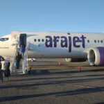 people-disembarking-from-an-arajet-boeing-737-max-8-aircraft-in-santo-domingo-860x484